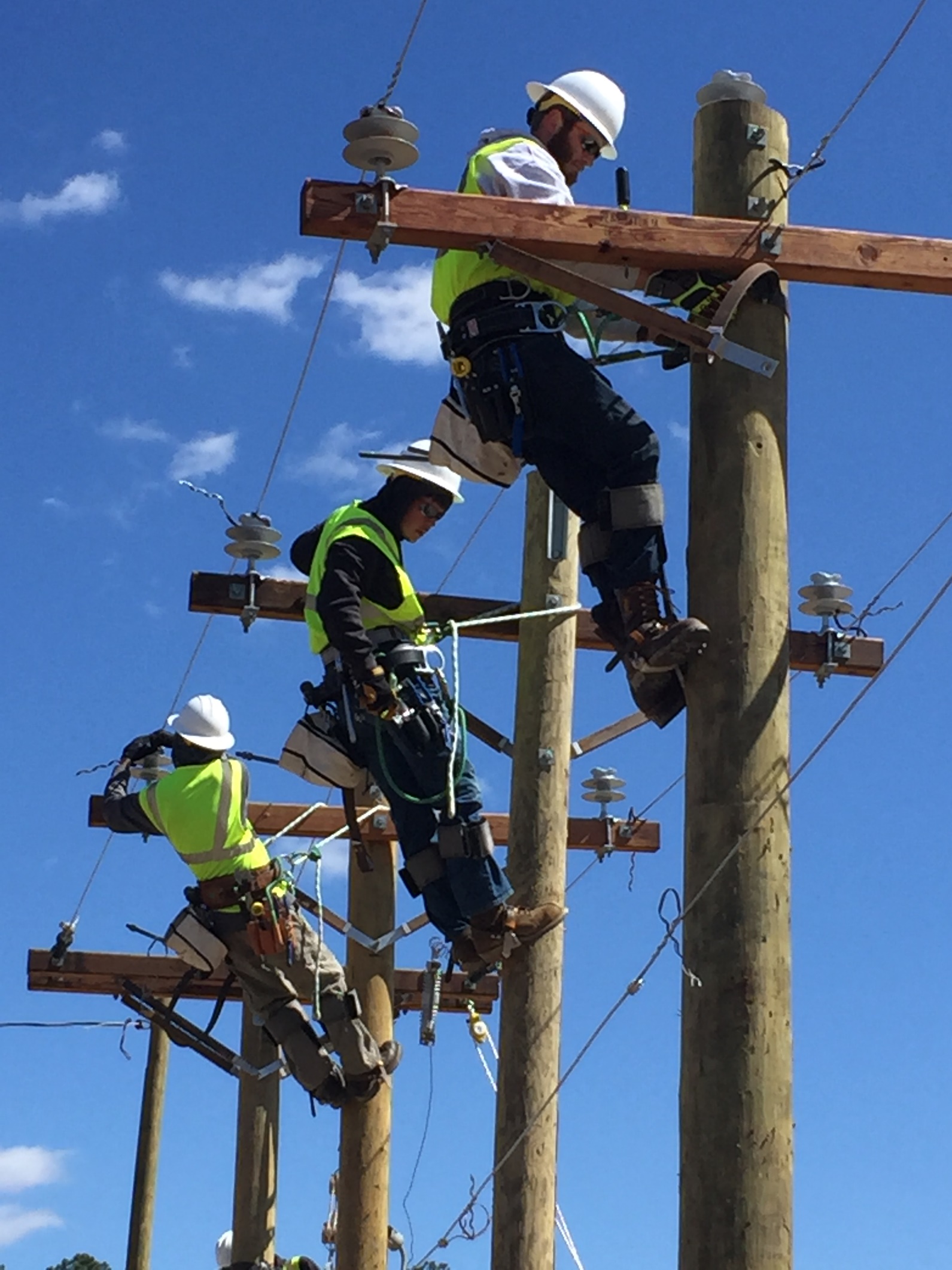 Line Worker School Students Atop Pole